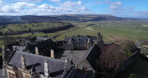 : Aerial footage of Stirling Castle with  the King’s Knot, a 16th century formal garden now only visible as earthworks, in the background. Flying away. photo