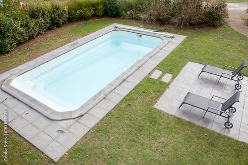 private home pool in green garden empty summer