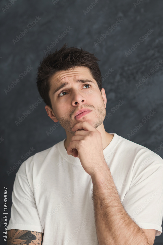 Pensive man posing with hand on chin Pensive man posing with hand on chin