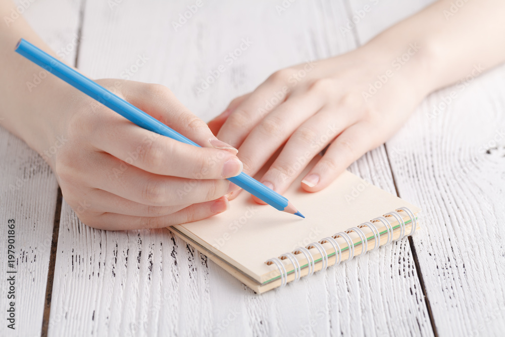 Writing memories note, close up female hand with pen Writing memories note, close up female hand with pen