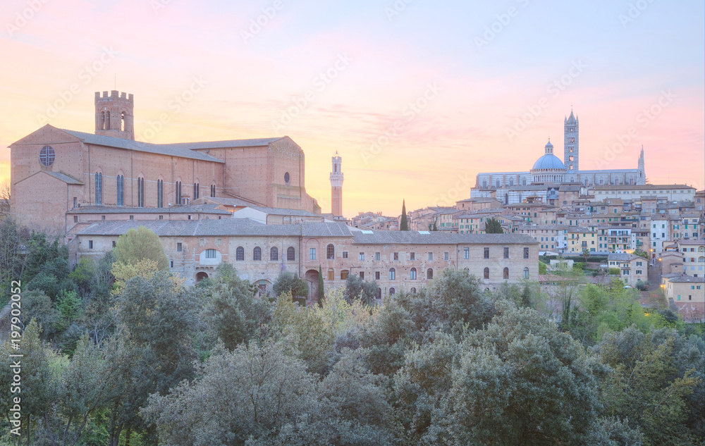 Beautiful panoramic view of the medieval old town of Siena at sunrise with Mangia Tower, Duomo Dome and Bell Tower ~ A UNESCO world heritage city in northern Italy ( faded color effect )