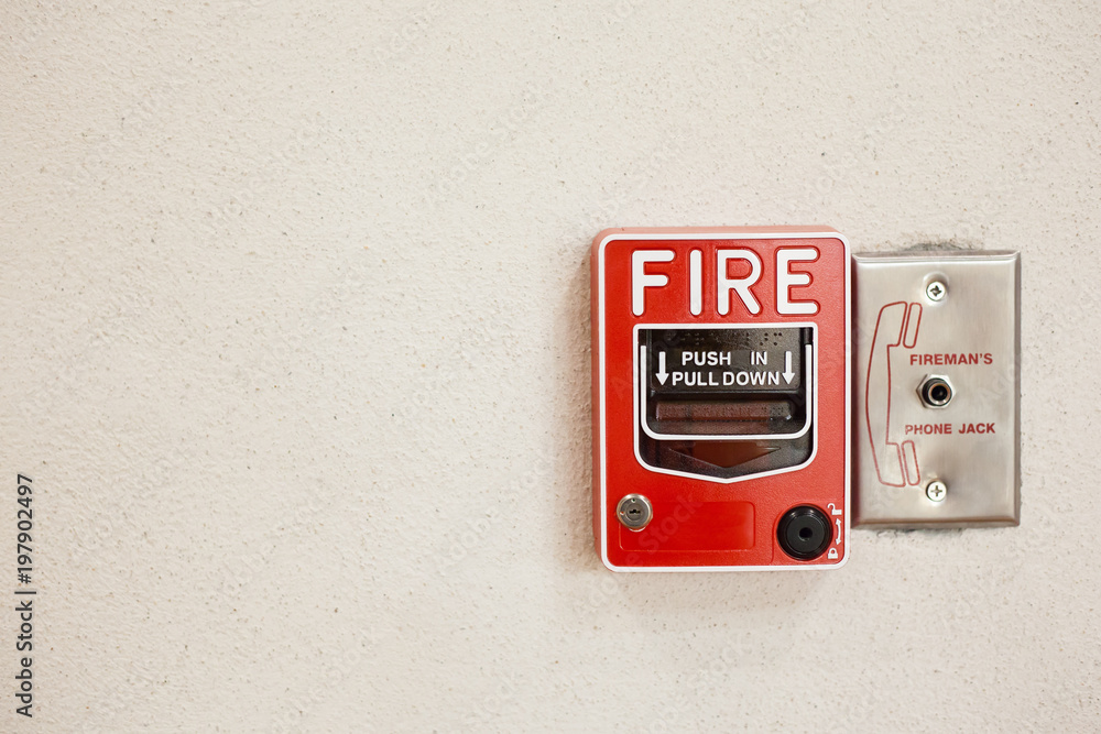 Red Fire alarm pull station switch install on white cement wall. Red Fire alarm pull station switch install on white cement wall.