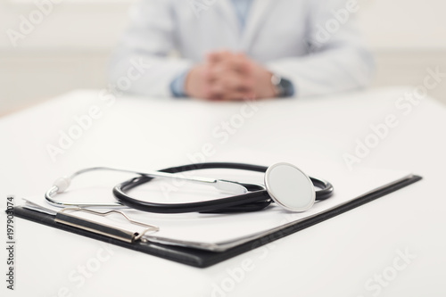 Stethoscope on desk, selective focus, closeup