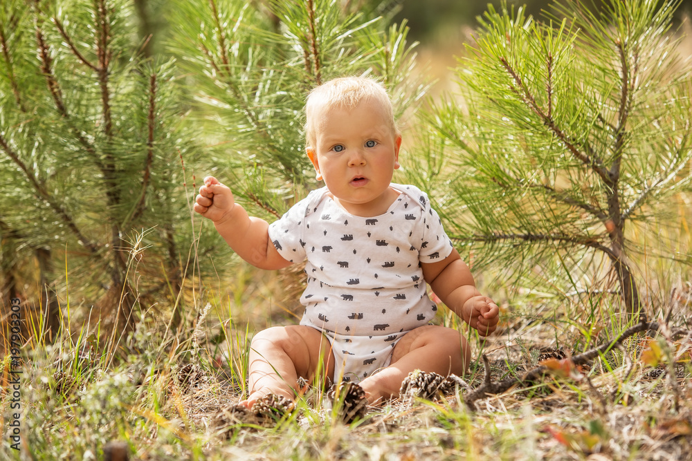Portrait of a baby boy in green pine forest Portrait of a baby boy in green pine forest