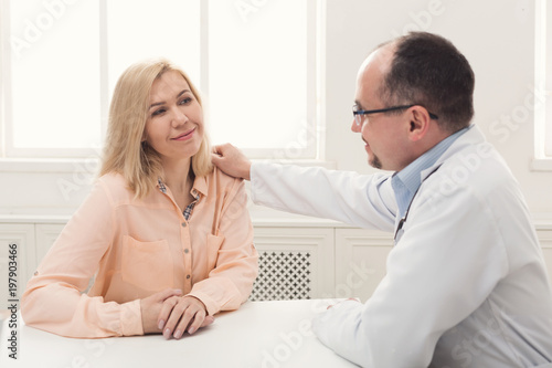 Doctor consulting woman in hospital