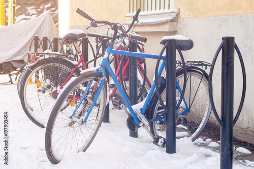 Bicycles in a snow, illuminated by sun #197903494