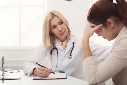 Doctor consulting woman in hospital photo
