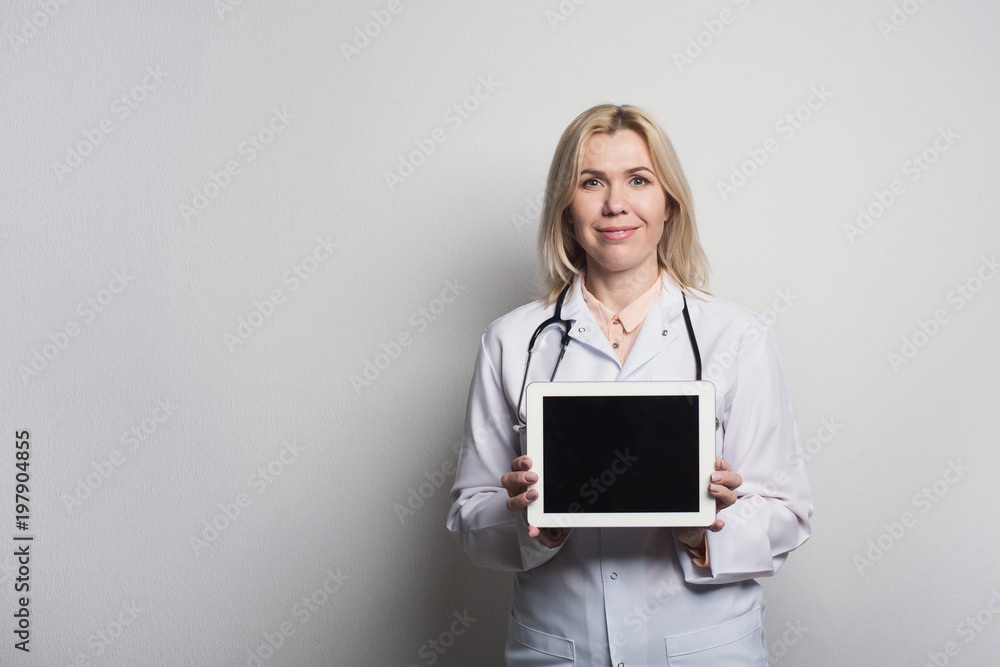 Doctor holding tablet computer with blank screen