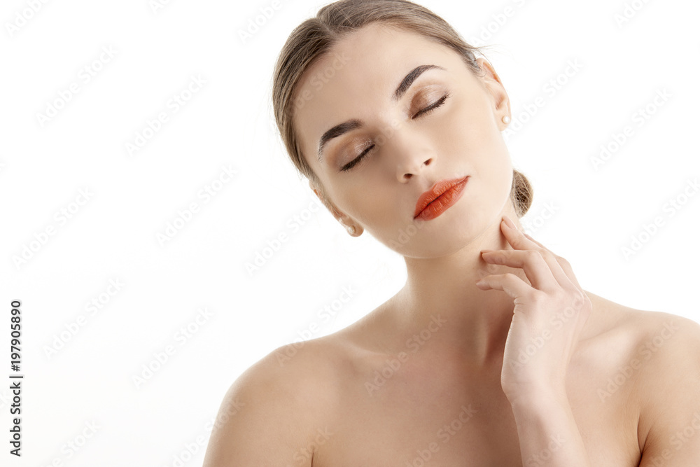 Close-up of beautiful young woman with red lips looking at camera while posing at isolated white background. Beauty shot in studio. Close-up of beautiful young woman with red lips looking at camera while posing at isolated white background. Beauty shot in studio.