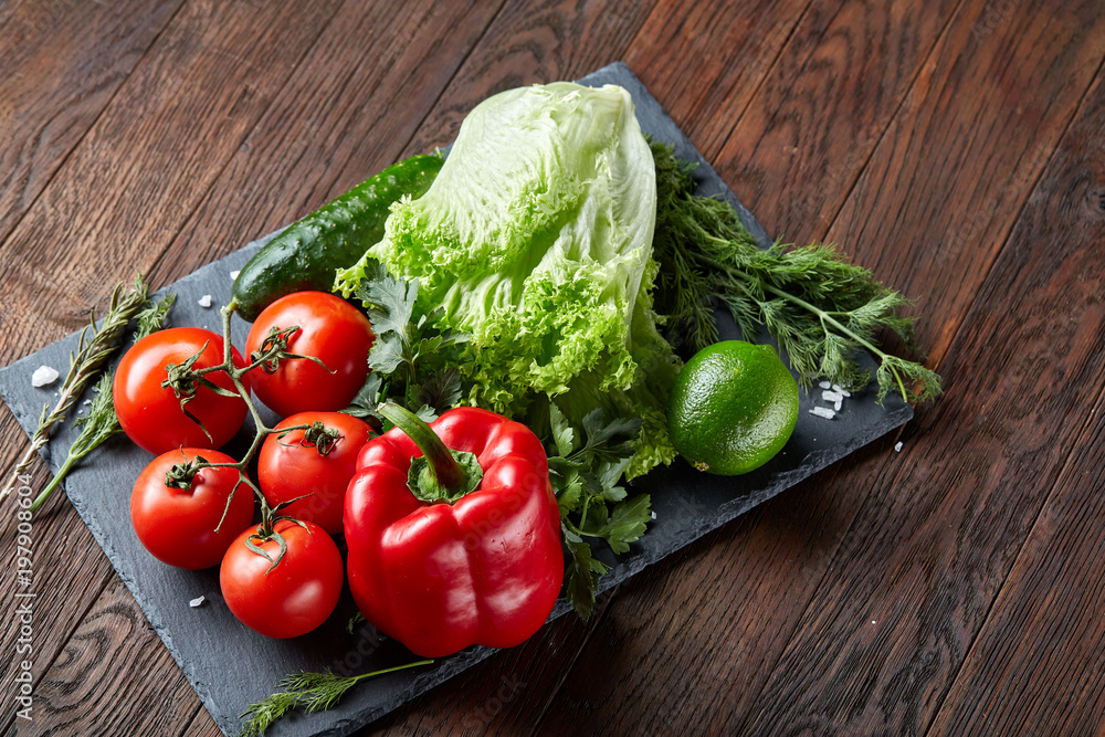 Close-up still life of assorted fresh vegetables and herbs on wooden rustic background, top view, selective focus. Close-up still life of assorted fresh vegetables and herbs on wooden rustic background, top view, selective focus.