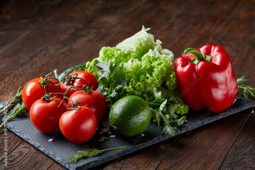 Close-up still life of assorted fresh vegetables and herbs on wooden rustic background, top view, selective focus. Close-up still life of assorted fresh vegetables and herbs on wooden rustic background, top view, selective focus.