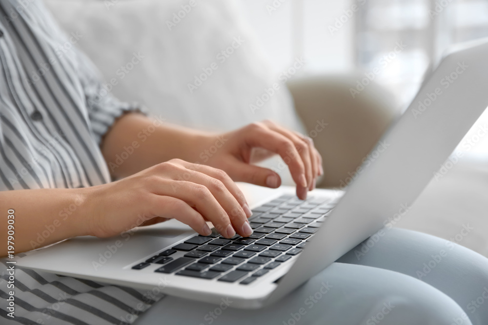 Young woman using laptop indoors, closeup Young woman using laptop indoors, closeup