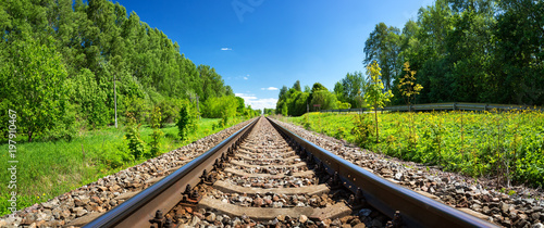 Railway outdoors on beautiful summer day. Landscape with railroad photo