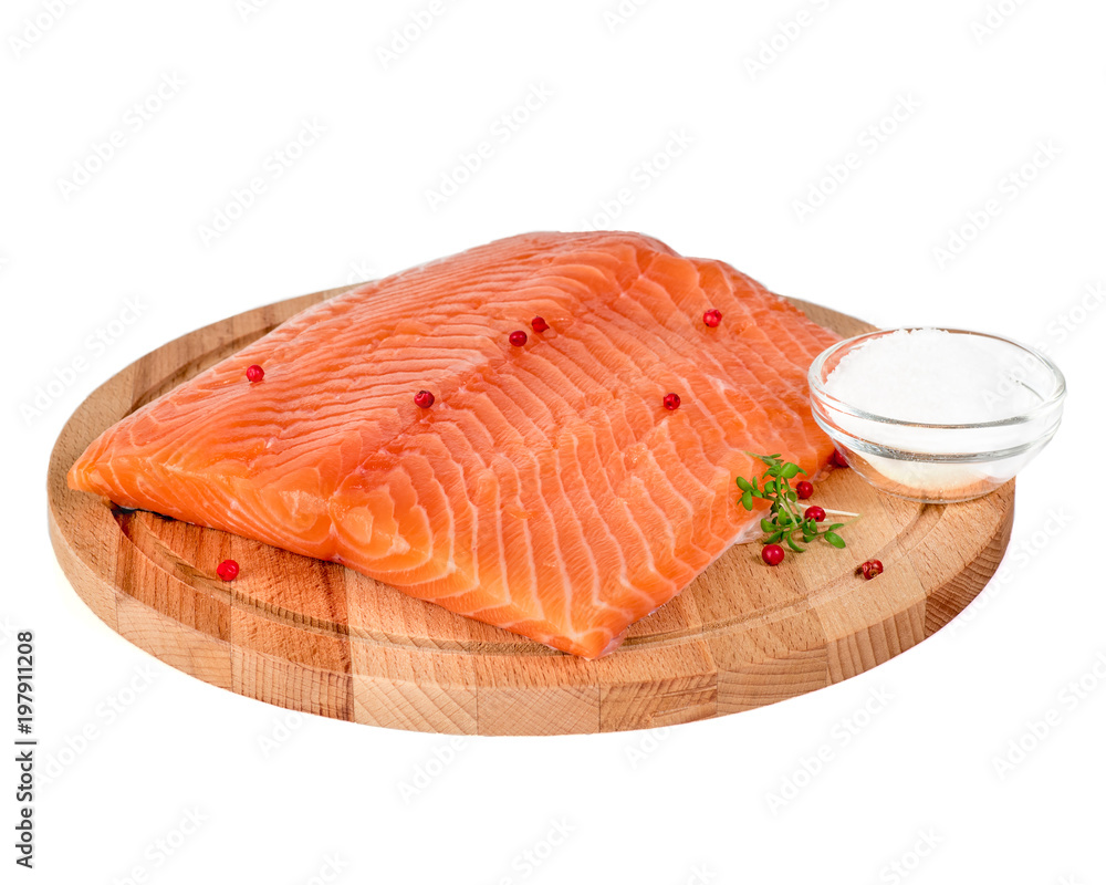 Fresh salmon fillet on wooden cutting board on white background, side view Fresh salmon fillet on wooden cutting board on white background, side view