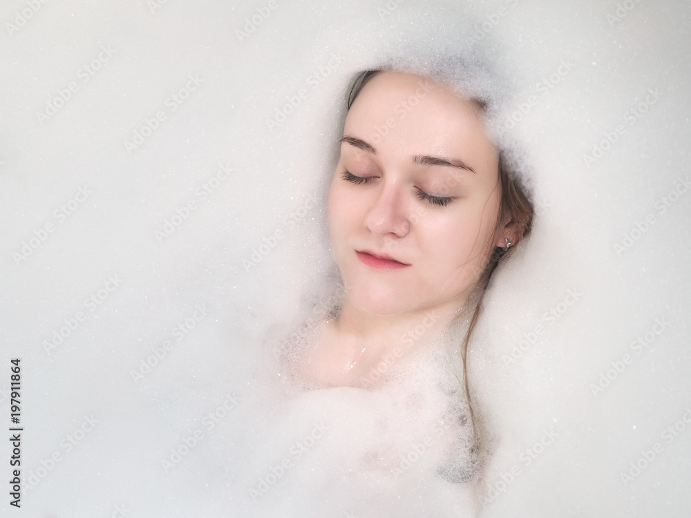 Portrait of a girl. Face in bath with foam Portrait of a girl. Face in bath with foam