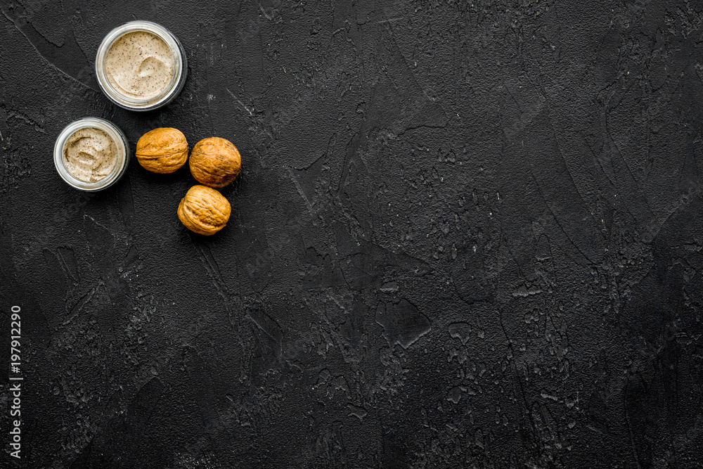 organic scrub with walnut for homemade spa on black background top view mockup organic scrub with walnut for homemade spa on black background top view mockup