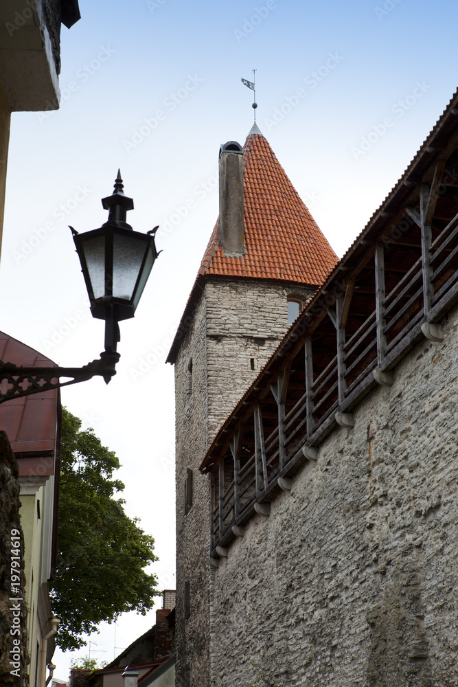 Street and tower of a city wall. Old city. Tallinn, Estonia. Street and tower of a city wall. Old city. Tallinn, Estonia.