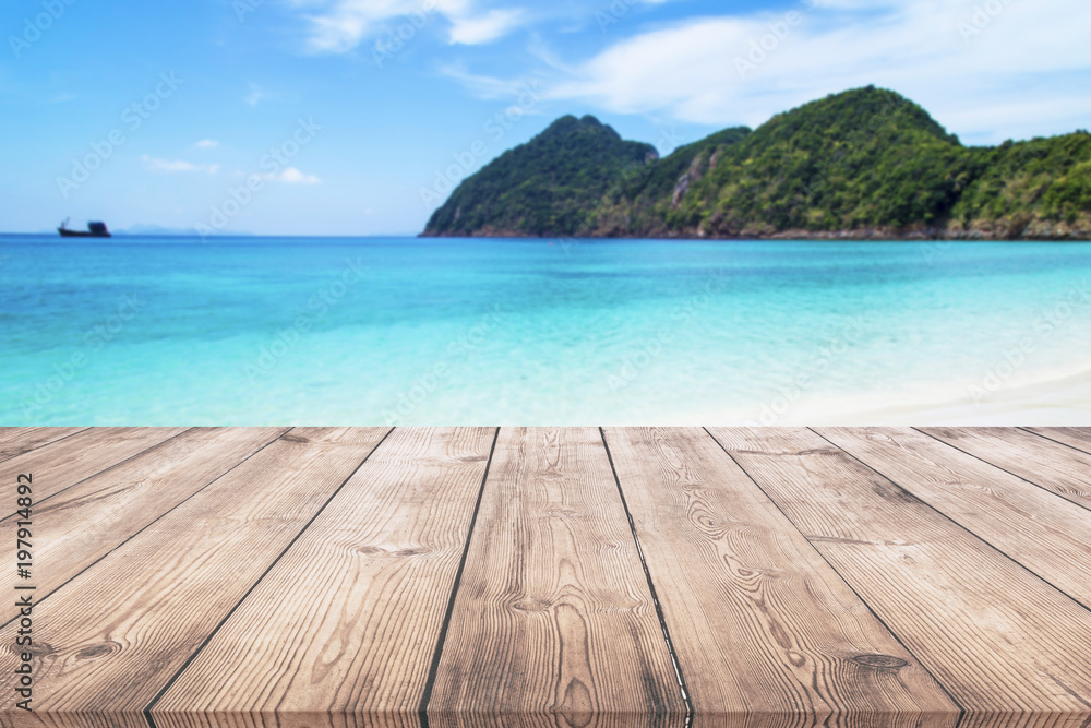 Wooden table with blue sea and beach background Wooden table with blue sea and beach background