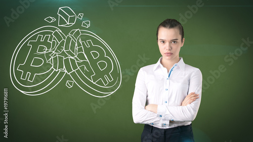 Woman standing near btc logo. Concept of virtual criptocurrency bitcoin dawnfall and correction. photo