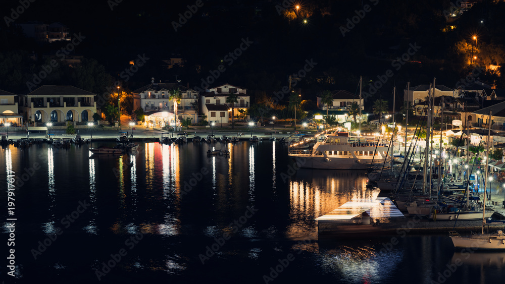 Panorama of the center of the night town of Sivota in Greece at night