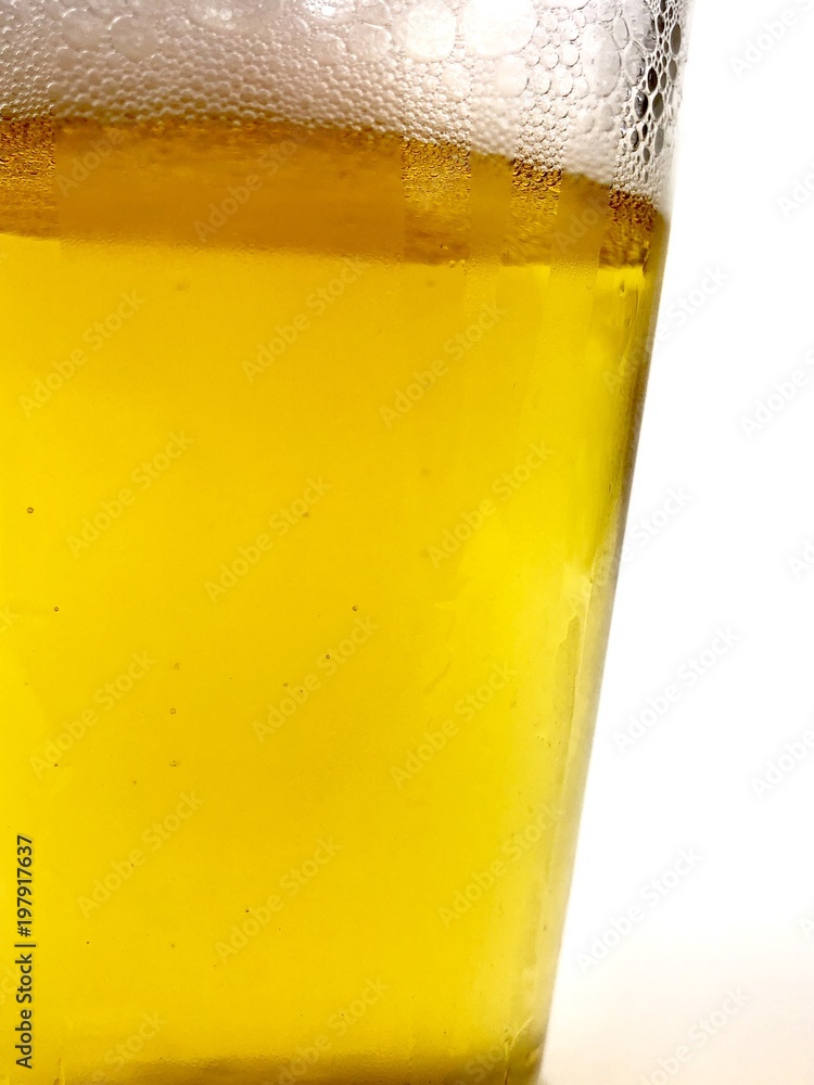 Close up of a glass of beer against a white background Close up of a glass of beer against a white background