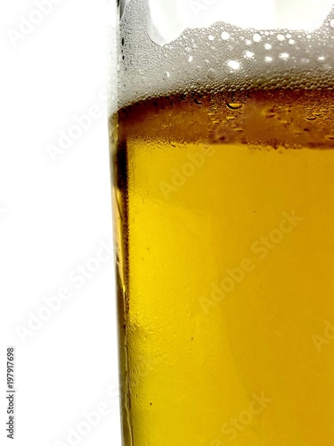 Side view of a clear glass of beer against a white background