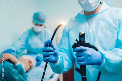 Endoscopy at the hospital. Doctor holding endoscope before gastroscopy photo