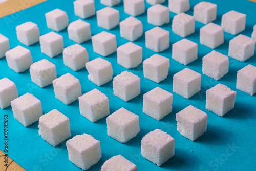Am image of food sugar background against blue paper. Minimalism style.