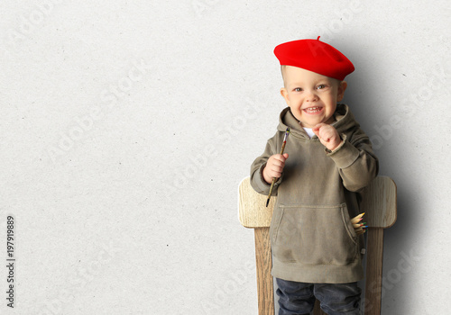 Little boy in a red beret are smiling
