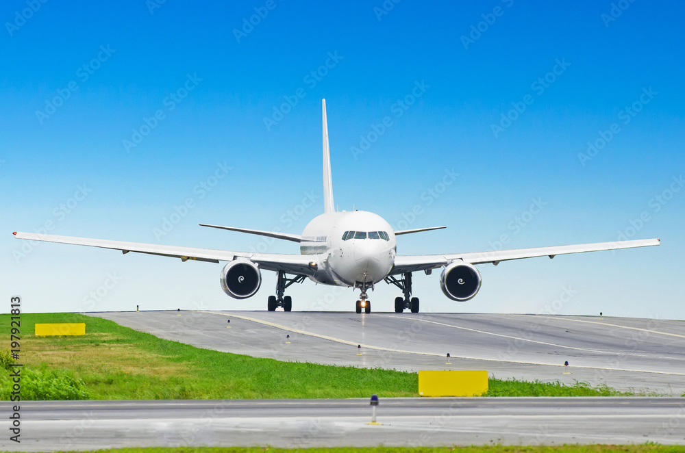 White passenger airplane taxiing at the airport. White passenger airplane taxiing at the airport.