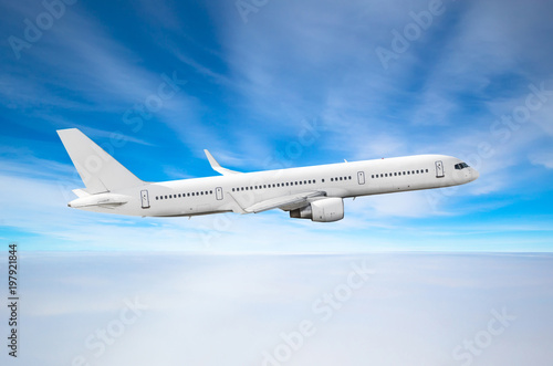 Passenger airplane fly on a hight above overcast clouds and blue sky.