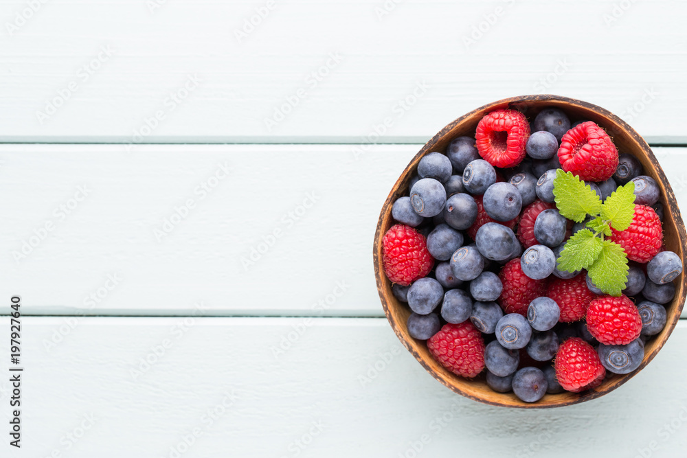 Juicy and fresh blueberries with green mint on rustic blue table. Juicy and fresh blueberries with green mint on rustic blue table.