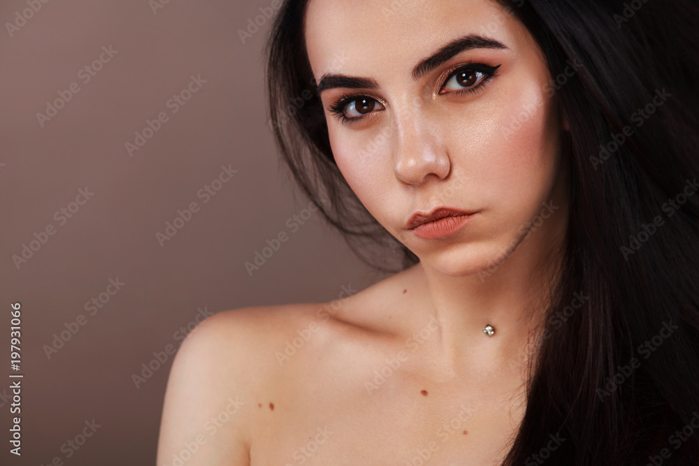 Closeup portrait of a beautiful woman. Pretty face of the young adult girl. Fashion model posing at studio. Cosmetology and spa concept. Closeup portrait of a beautiful woman. Pretty face of the young adult girl. Fashion model posing at studio. Cosmetology and spa concept.