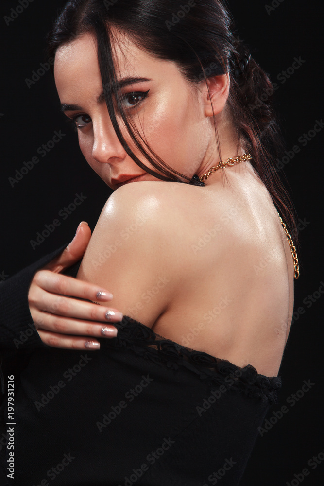 Portrait of beautiful sexy brunnete girl, on black background. Pretty girl model. A brunette woman in a black dress. Portrait of beautiful sexy brunnete girl, on black background. Pretty girl model. A brunette woman in a black dress.