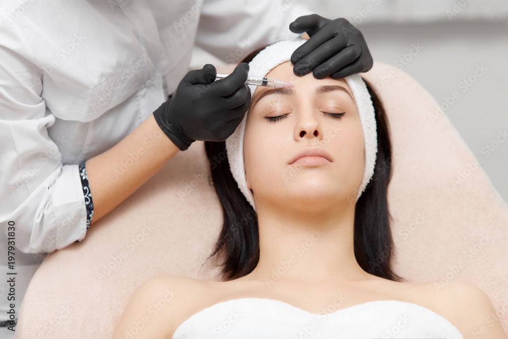 Fototapeta premium Cosmetology specialist giving lifting injection to beautiful woman.