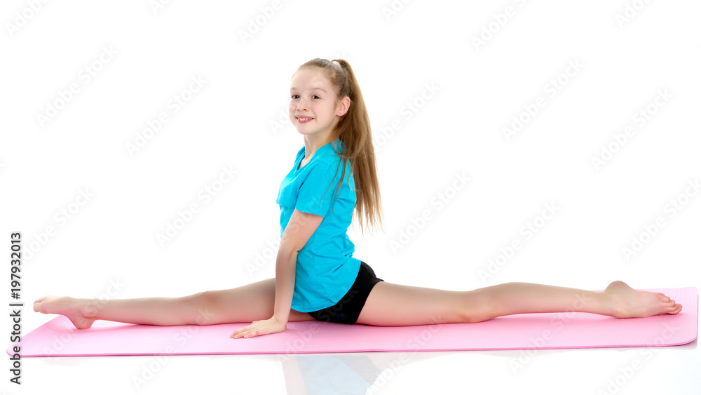 Girl gymnast perform the twine exercise. Girl gymnast perform the twine exercise.