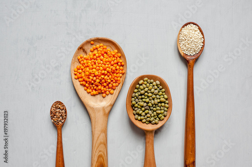 Close-up of wooden spoons with lentils and other grains. Handmade spoons.