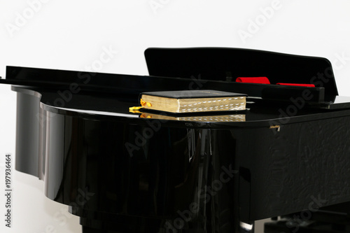 The Bible on the Black Piano