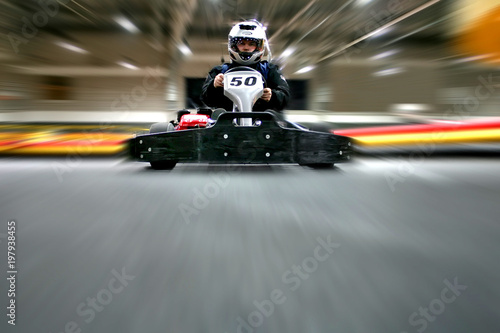 The man is in the go-kart on the karting track