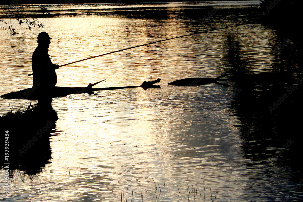 The silhouette of the fisherman on fishing on sunset. Black and