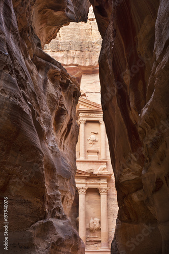 view to the old temple in rock through narrow canyon in Jordan