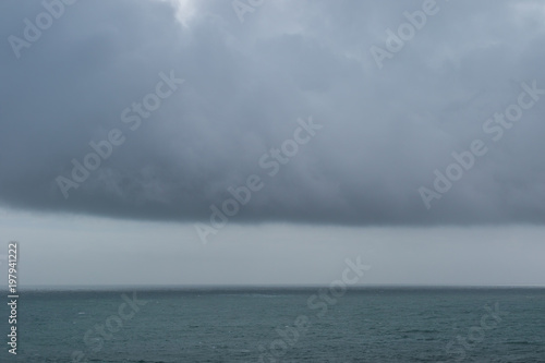 Amazing water landscape with heavy wall clouds over the ocean surface