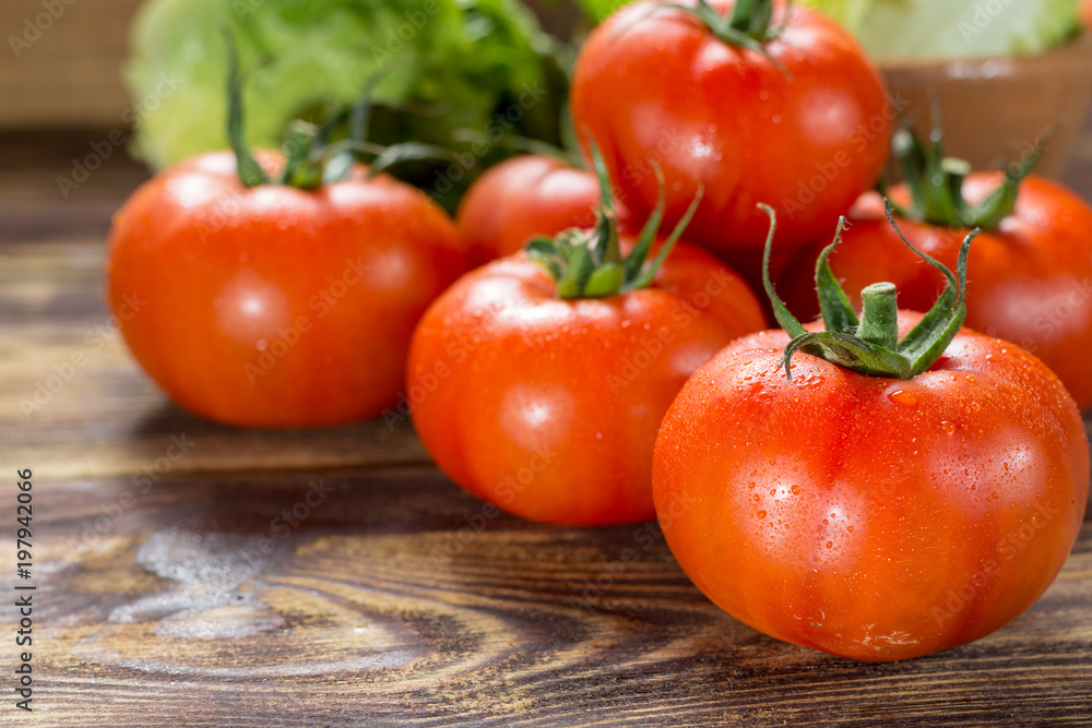Tasty red ripe tomatoes gourmato from Belgium with green lettuce, ingredients for healthy salad close up Tasty red ripe tomatoes gourmato from Belgium with green lettuce, ingredients for healthy salad close up