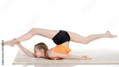 The gymnast performs an acrobatic element on the floor.