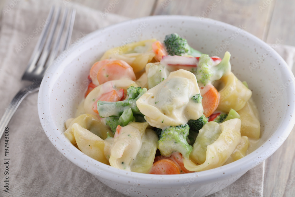 Tortellini with vegetables under cream sauce Tortellini with vegetables under cream sauce