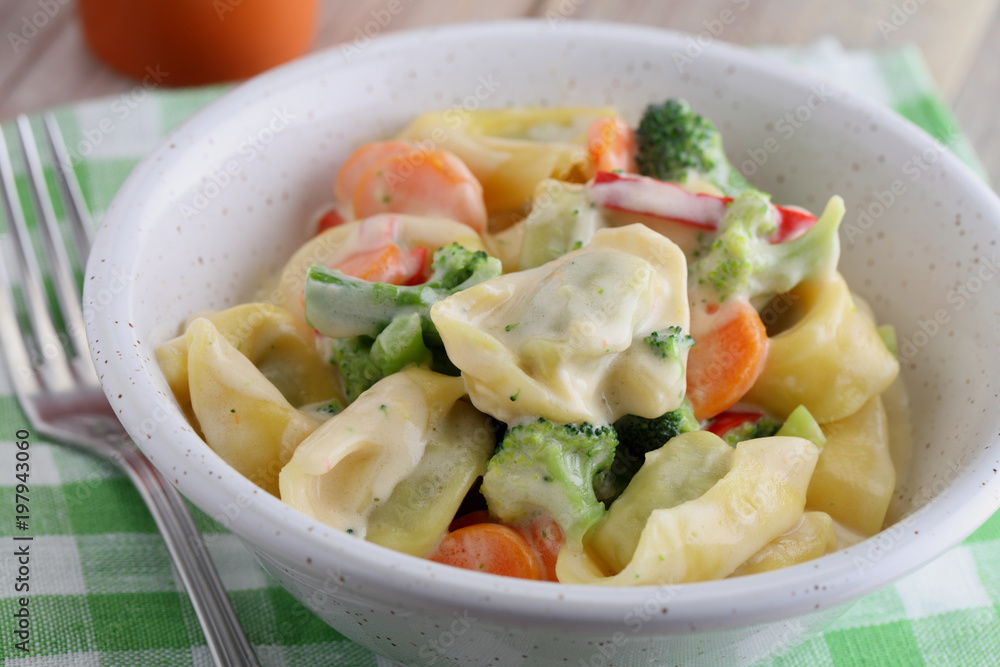 Tortellini with vegetables under cream sauce Tortellini with vegetables under cream sauce