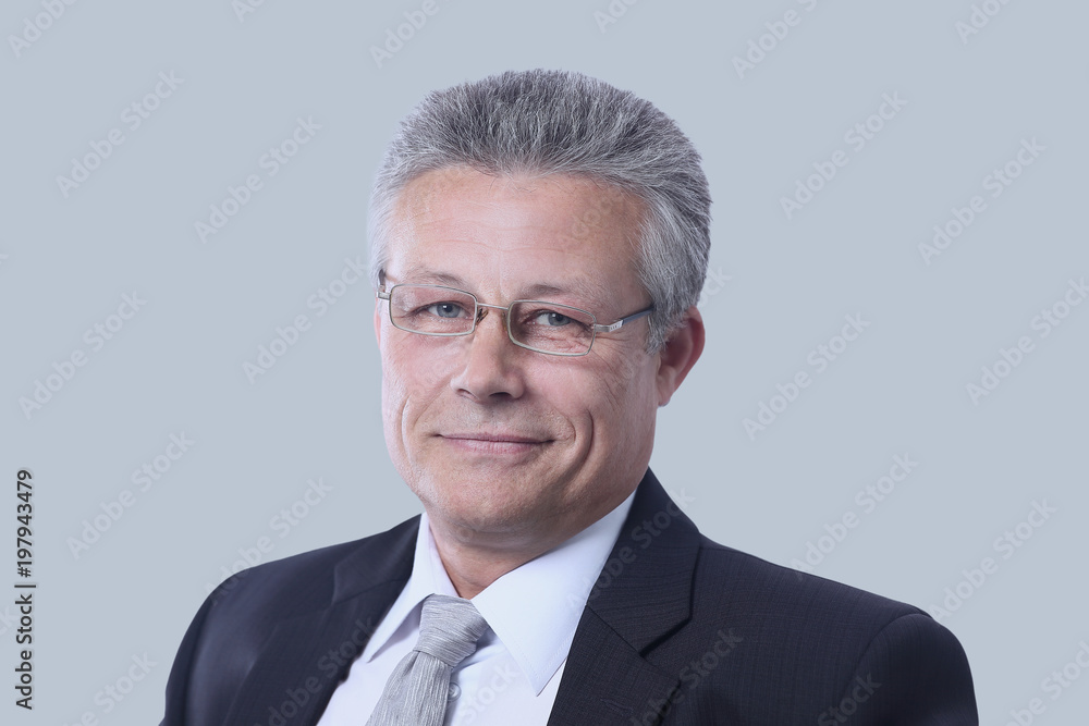 Portrait of a mature gray-haired business man isolated on gray Portrait of a mature gray-haired business man isolated on gray