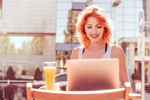 Business woman working on laptop in a cafe