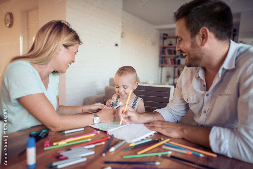 Parents with a son drawing at home Parents with a son drawing at home