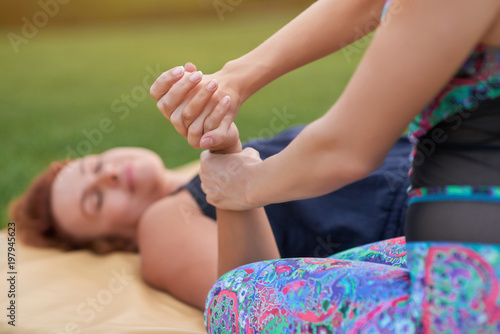 Hands thai massage and relaxing. Caucasian women practising thai massage.